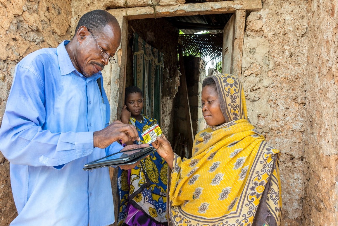 A district malaria officer in Zanzibar tests a household member for malaria. Coconut Surveillance, and mHealth application developed by RTI, is being used in an active effort to eradicate the disease from Zanzibar.