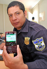 Photo of police officer with Ushahidi phone client.