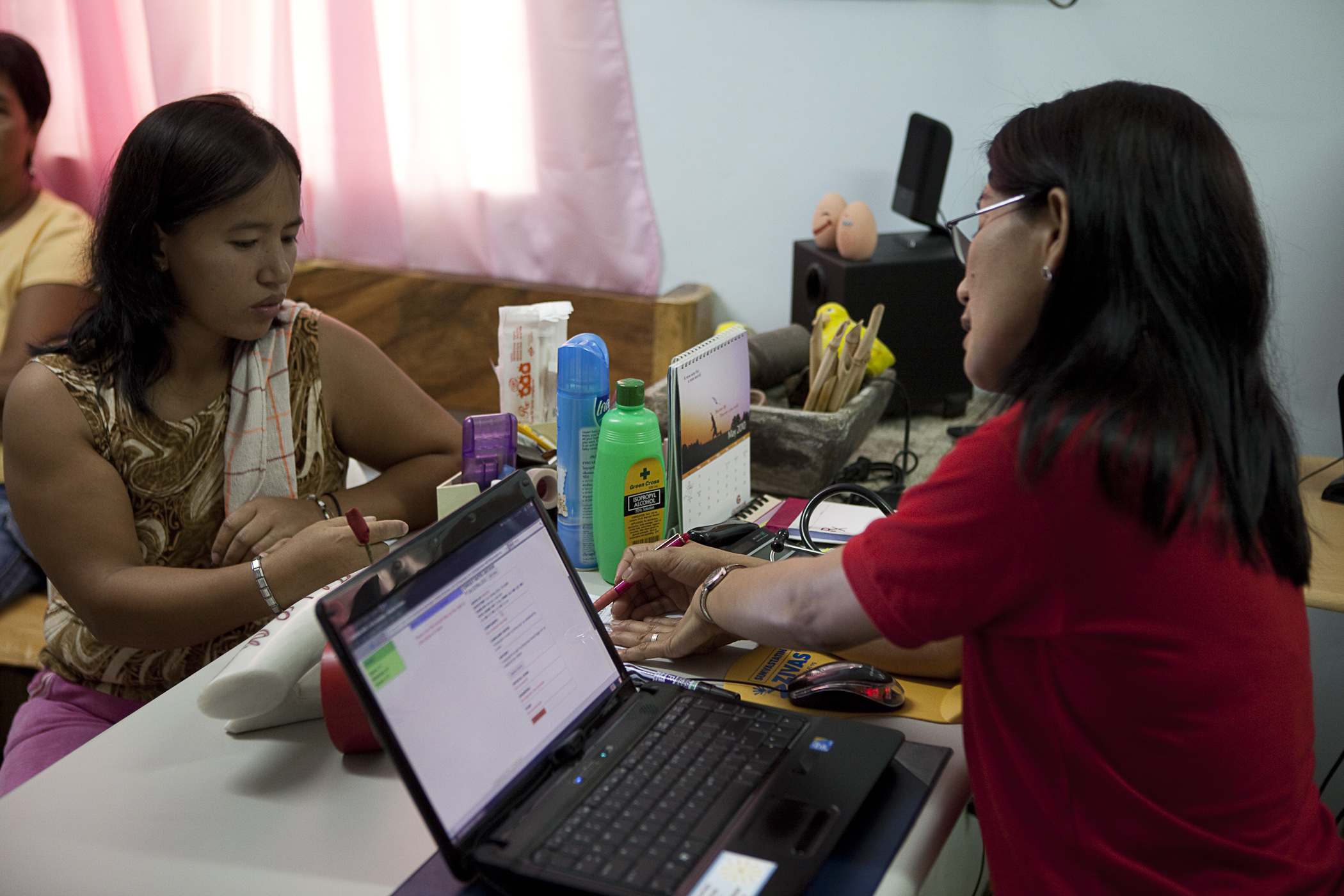 Photo showing a nurse using the WAH EMR in a rural health unit.